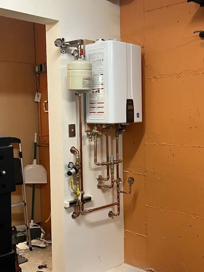 Plumbing technician inspecting water heater connections in Santa Ynez